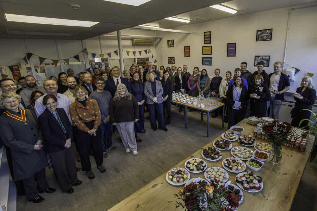 Group photo of colleagues at the mill standing in the canteen