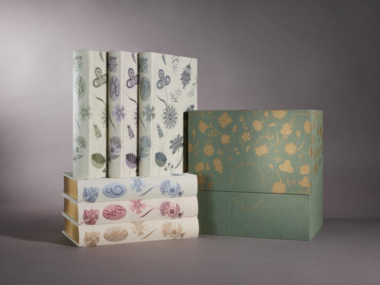 Collection of Jane Austen books with display box, all covered in fabric.