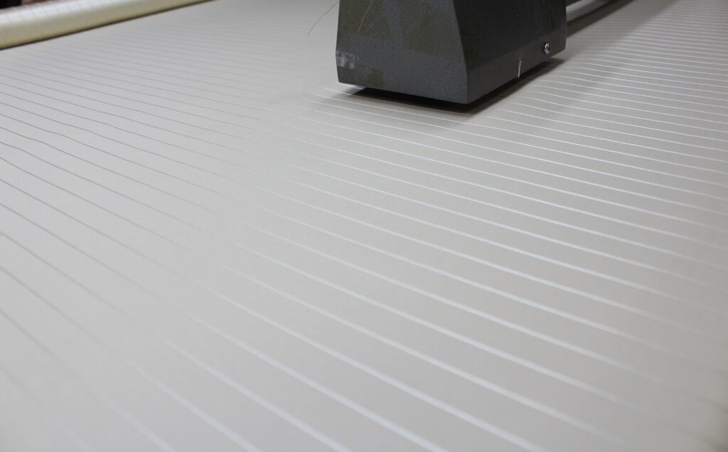 A silk and wool fine stripe in pale grey.