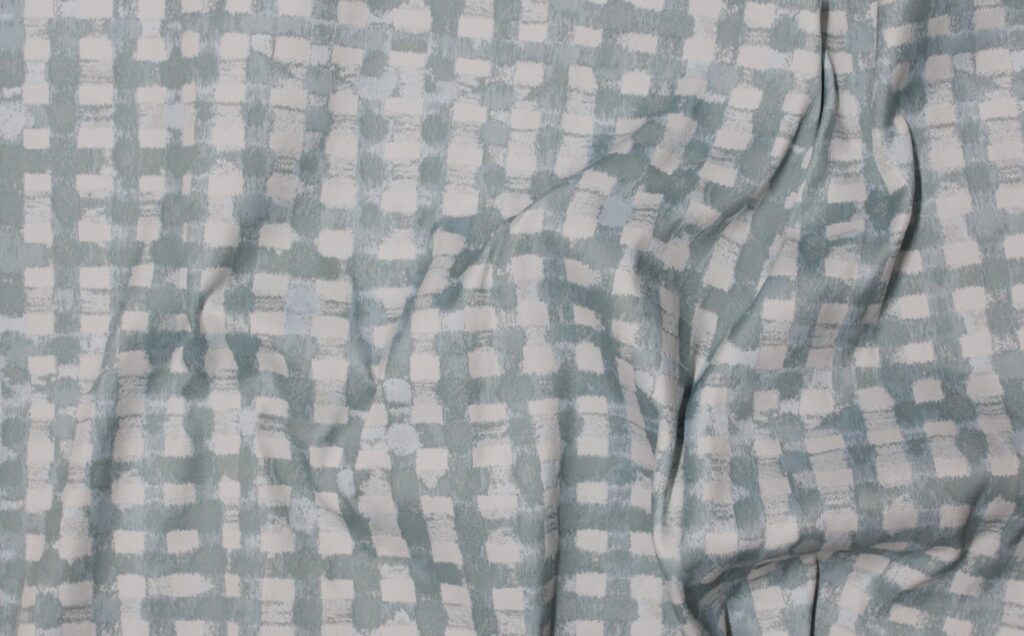 A digitally distorted grey check fabric.