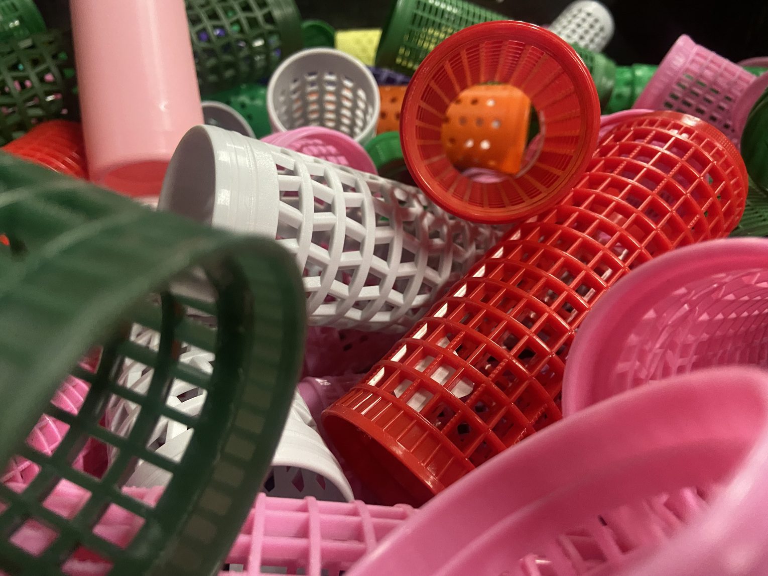 Scattered colourful plastic empty yarn cones